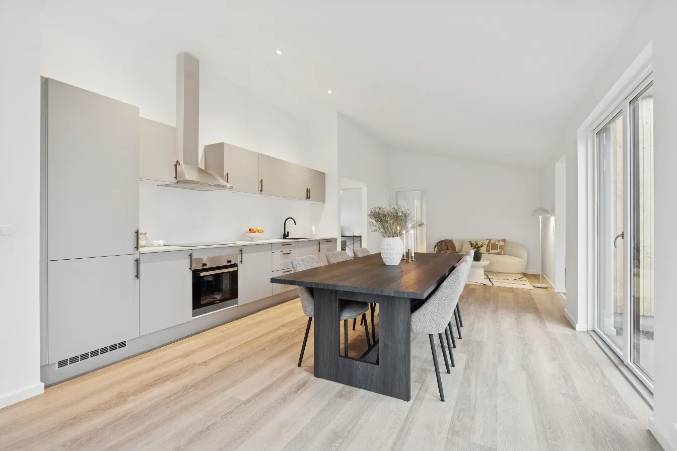 Bright open-plan kitchen and living room at Esrumhusene